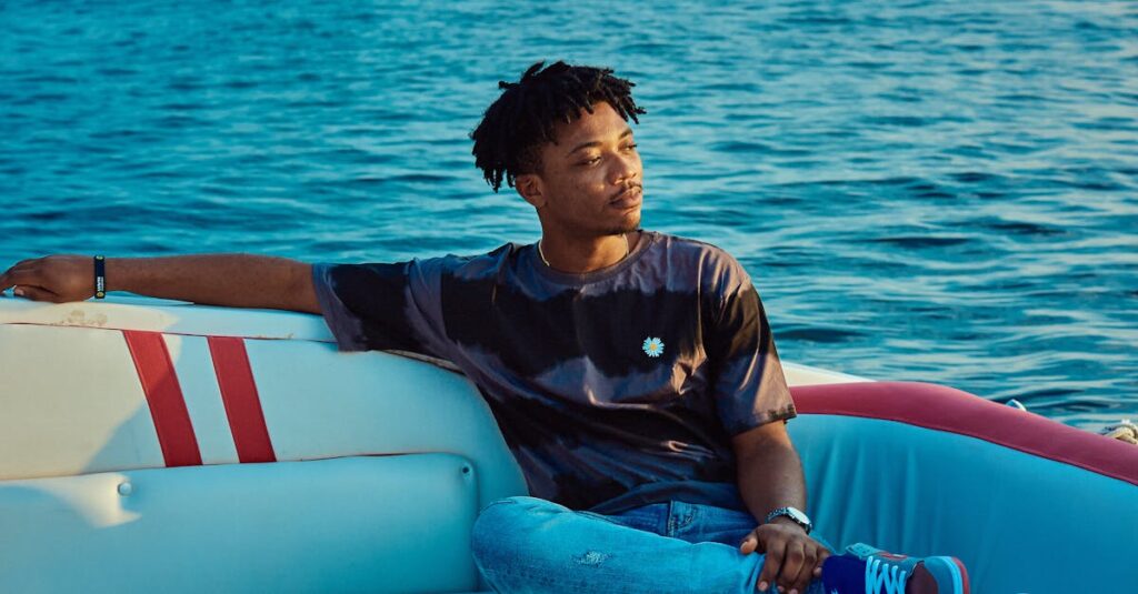 A young man enjoying a serene moment on a boat in Lagos, Nigeria.