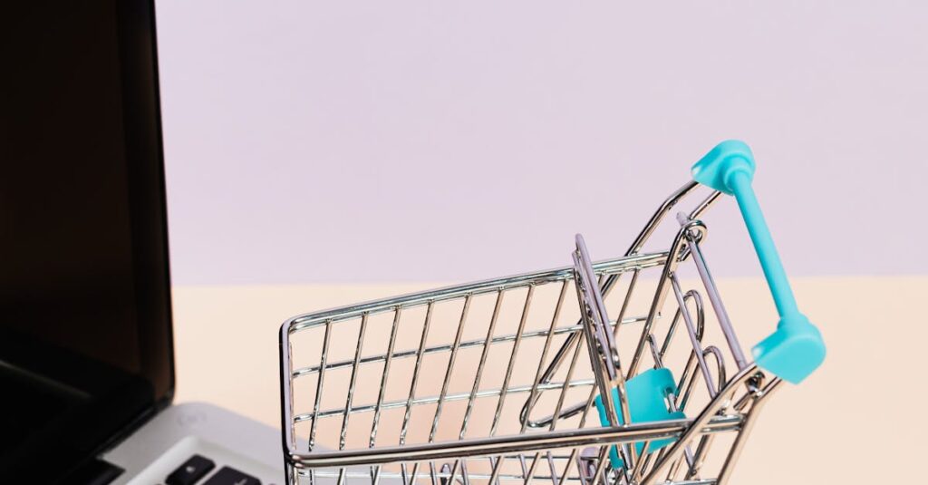 Mini shopping cart on a laptop symbolizes online shopping and e-commerce themes.