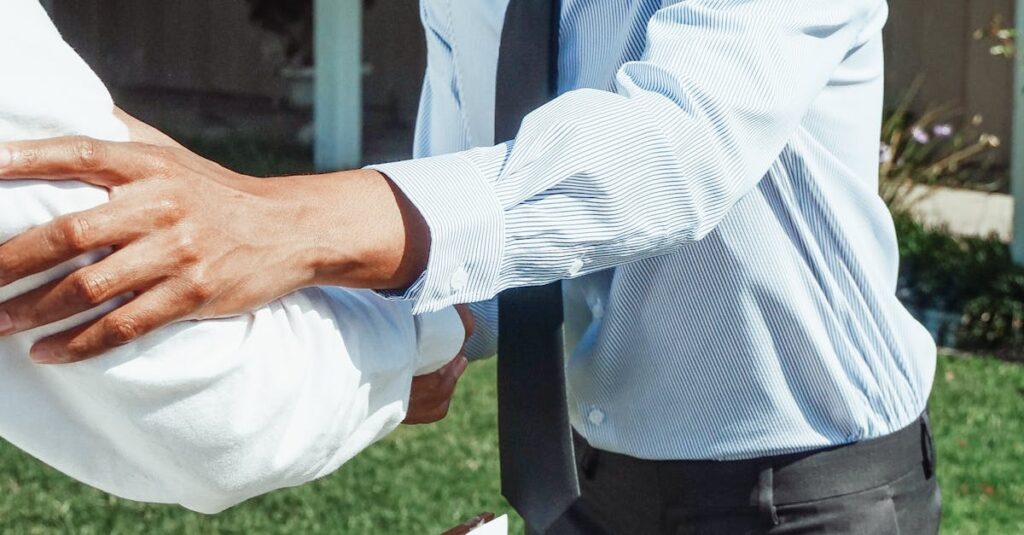 Man shaking hands outside a house with a 'Sold' sign, marking a successful real estate transaction.