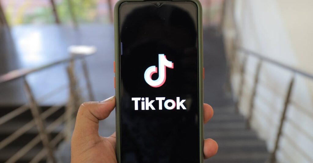 A close-up of a hand holding a smartphone displaying the TikTok app inside a modern building.