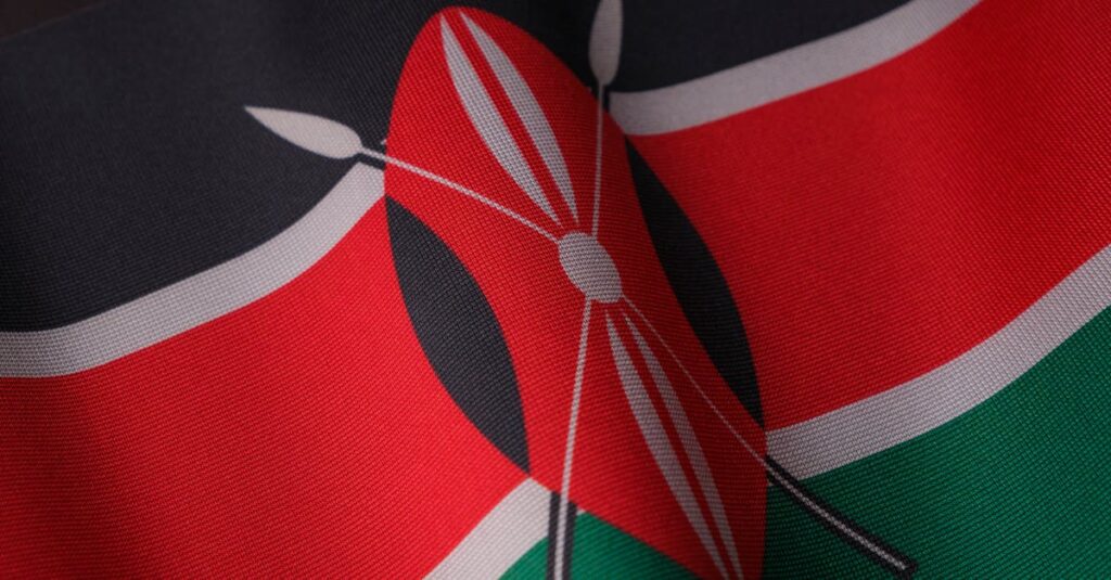 Detailed close-up of the vibrant Kenyan flag waving with texture visible.