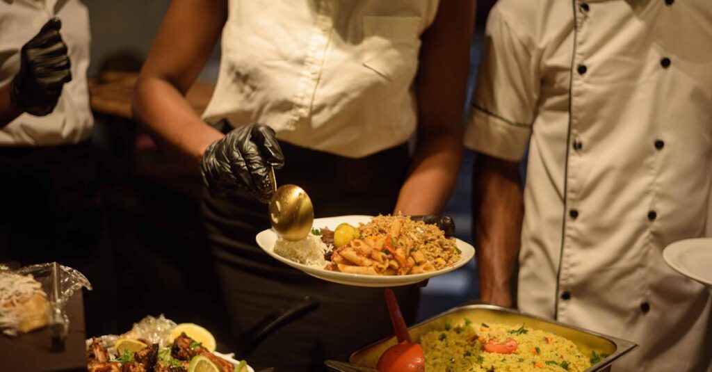 Catering service in Enugu, Nigeria with delicious buffet offerings served by staff.