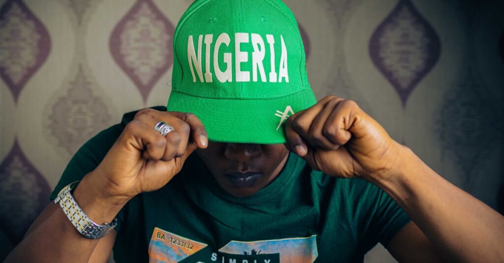 Portrait of person with Nigerian hat, emphasizing identity and style indoors.