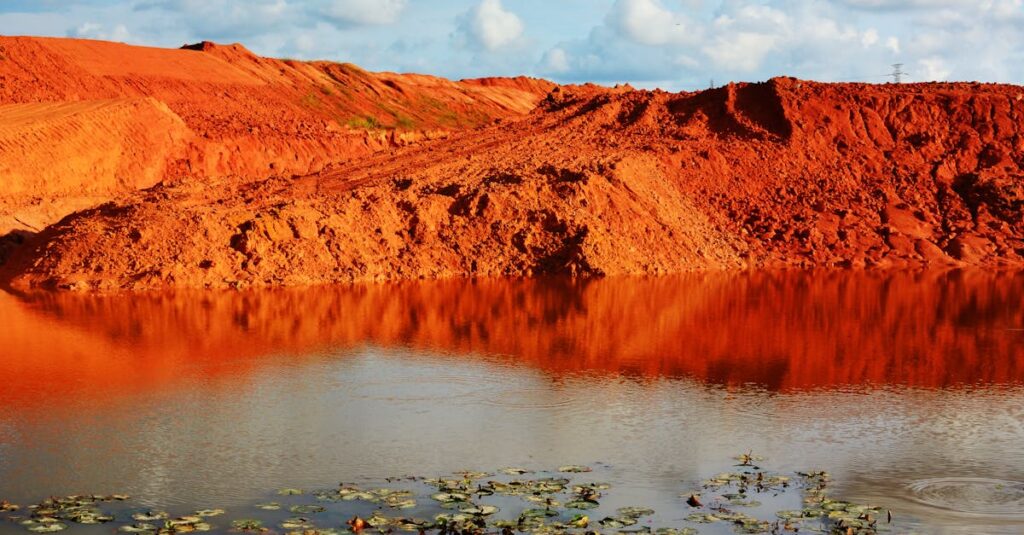 Scenic view of red earth reflected in a pond in Johor Bahru, Malaysia.