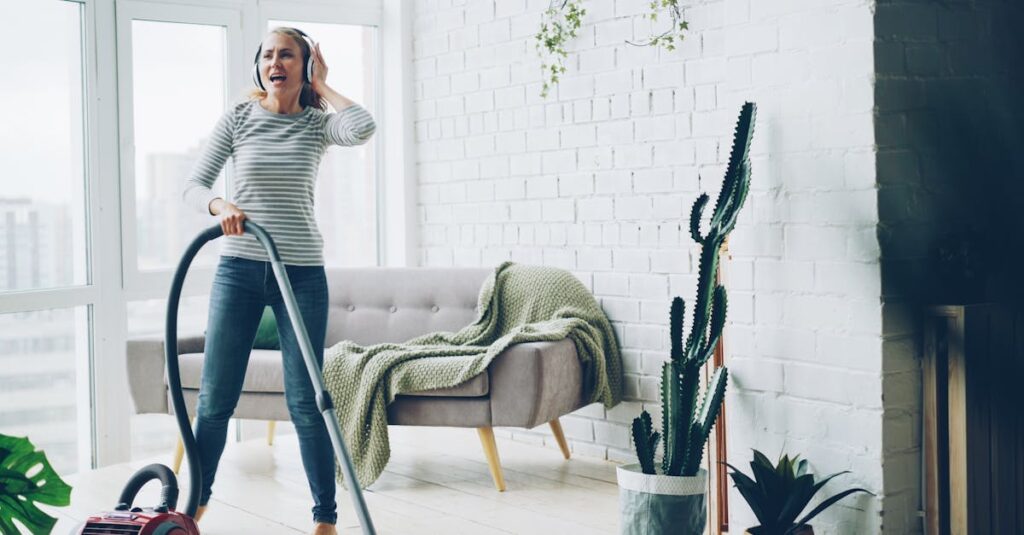 Cheerful woman vacuuming indoors while listening to music.