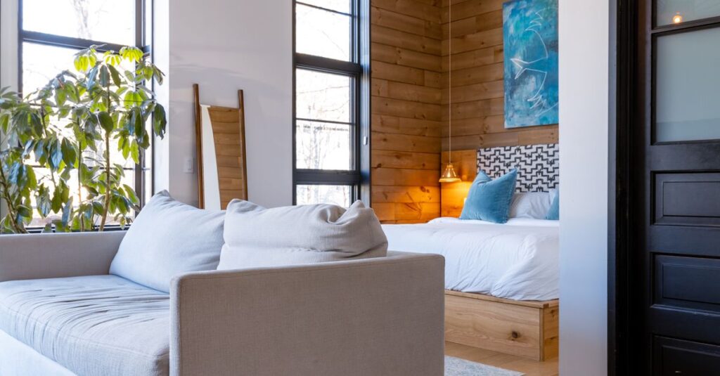 Contemporary cabin interior featuring a cozy bedroom with wooden accents and modern decor.