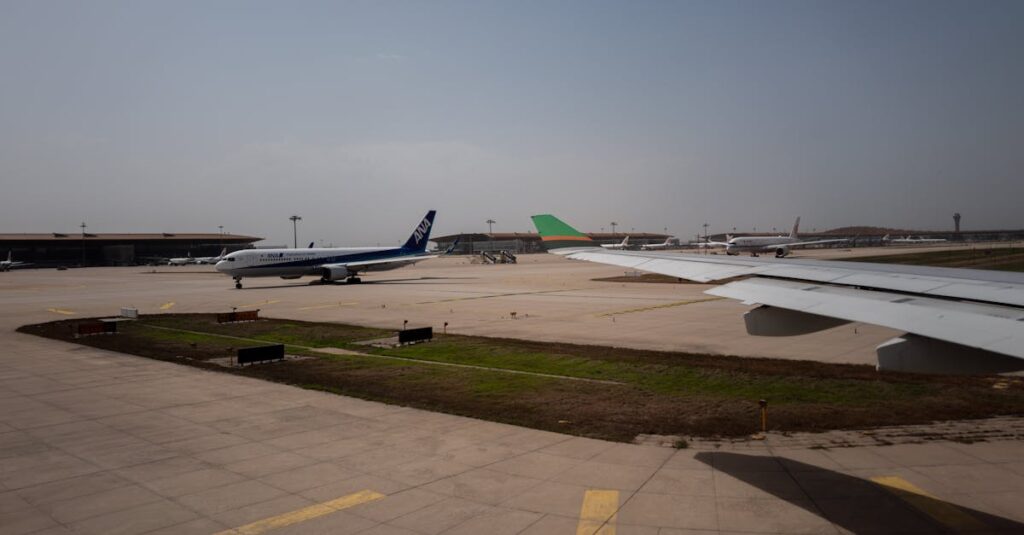 Airplanes taxiing on runway at a busy airport under clear skies.
