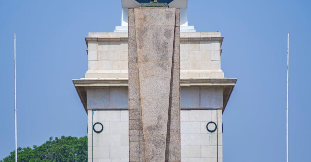 The Independence Arch in Accra, a symbol of Ghana's freedom, under a bright blue sky.