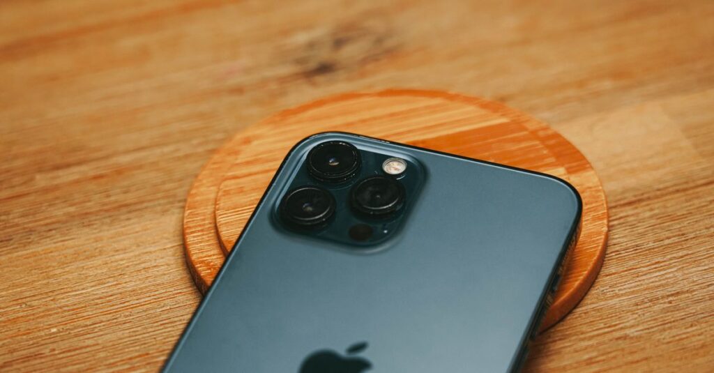 Detailed close-up of a modern smartphone camera on a textured wooden surface.