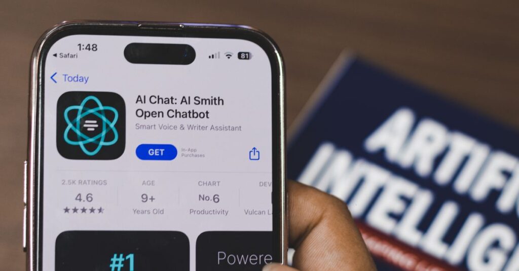 Hand holding a smartphone with AI chatbot app, emphasizing artificial intelligence and technology.